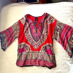 Orange, pink, and black bohemian style Free People tunic.